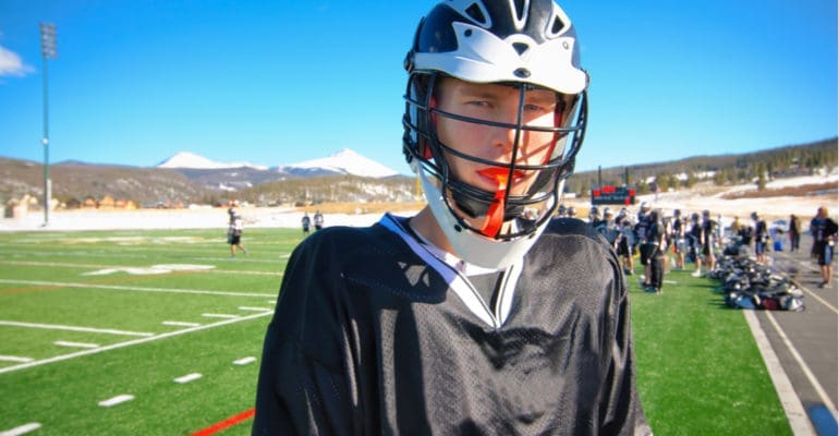 Young lacross player wearing a custom dental mouthguard