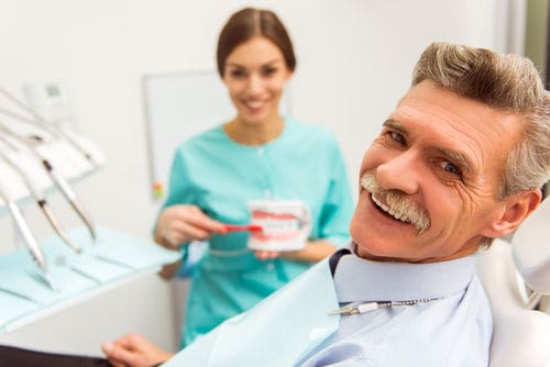 Patient with hygienist discussing gum disease